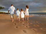 family walking on the beach at their vow renewal on maui